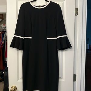 Gently fitted Calvin Klein pencil dress in black with white details